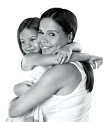 Woman holding little girl, both smiling